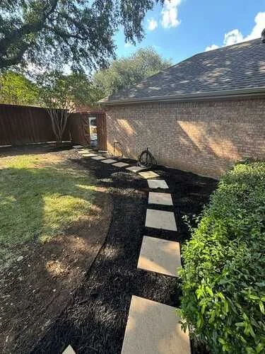 Stepping-stone path through a mulched backyard garden