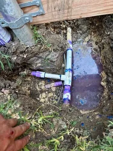 Exposed sprinkler plumbing during an irrigation repair
